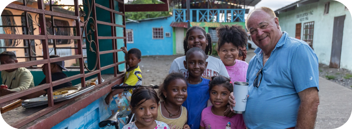 Children and a Driven Hearts supporter together in their community